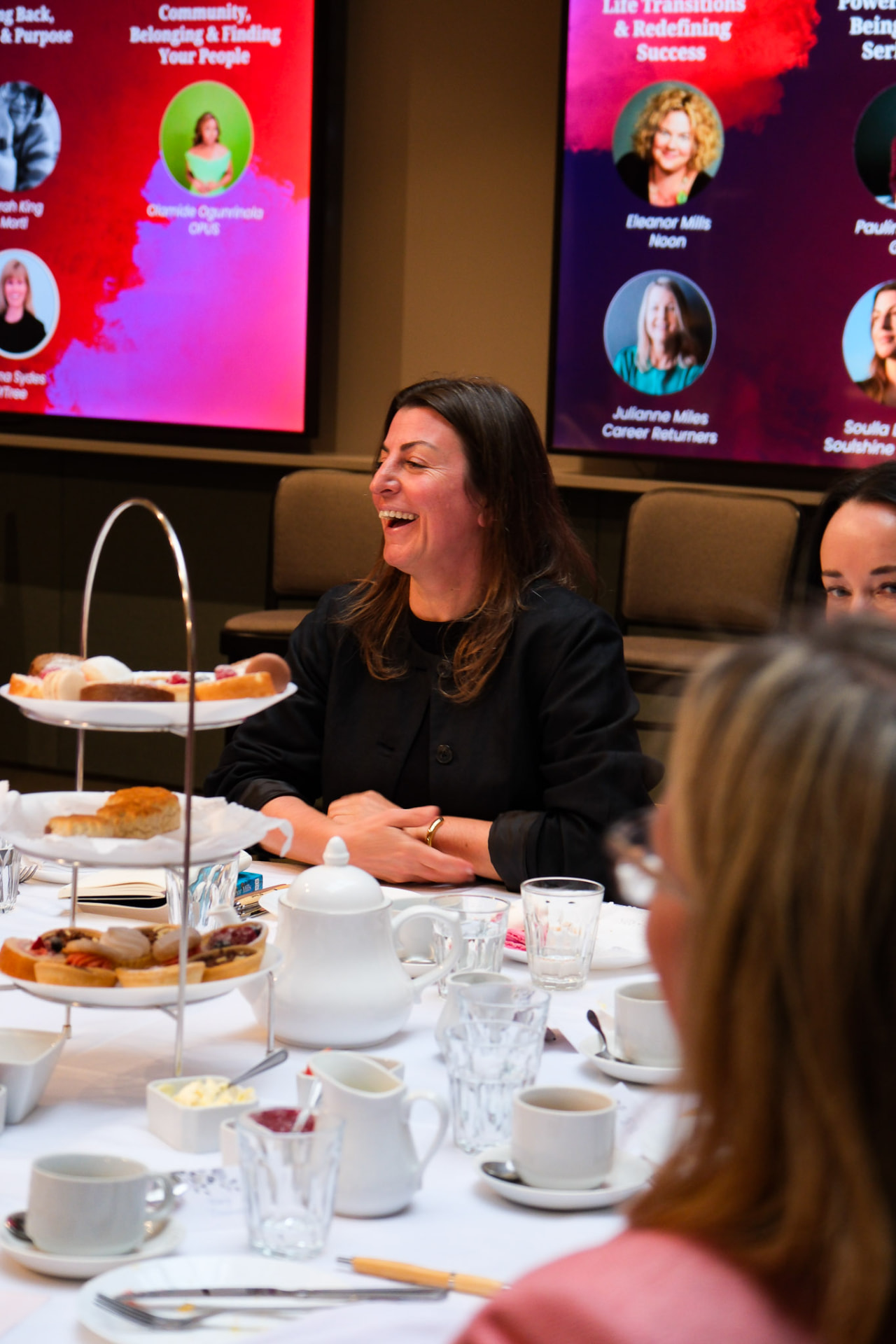 A guest laughing during an EmpowerHER afternoon