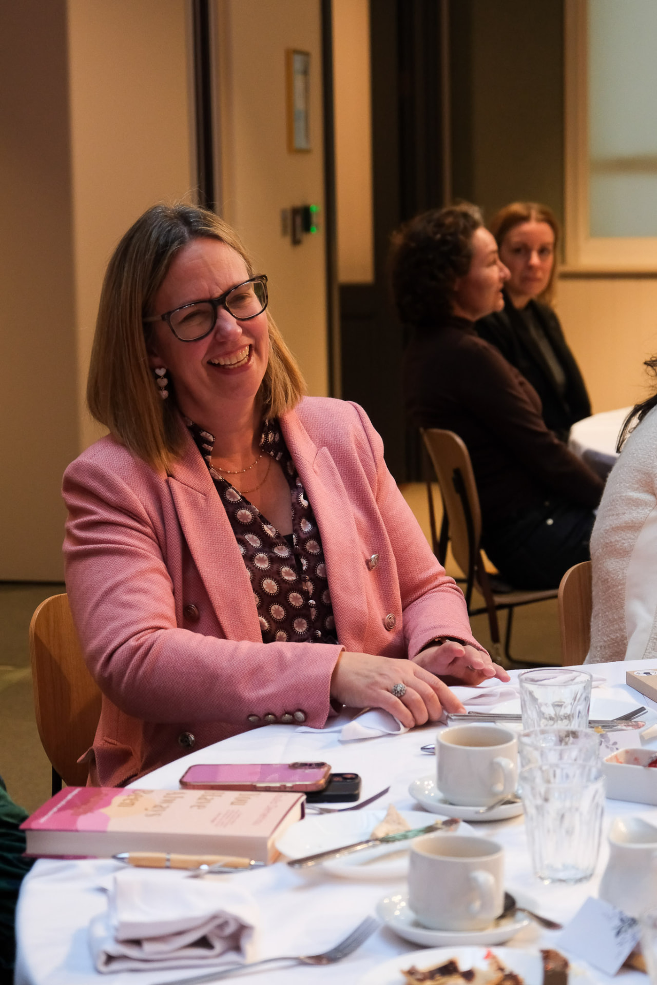 A guest smiling at an EmpowerHER afternoon