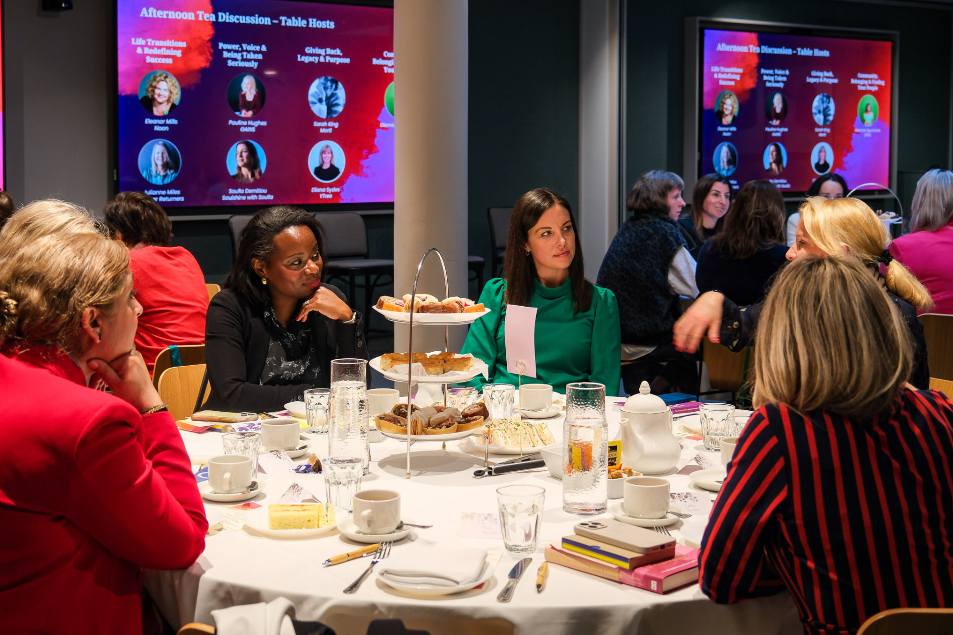 Women in conversation around a table at EmpowerHER