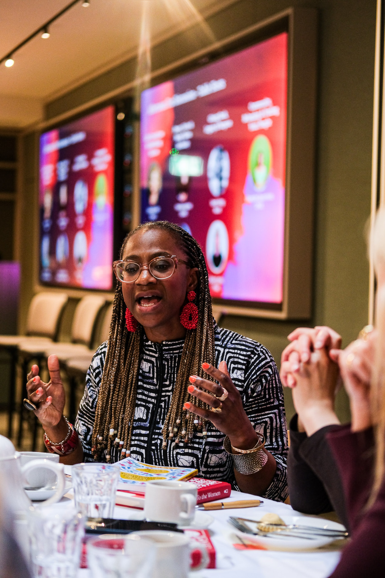 A guest sharing her perspective at the table