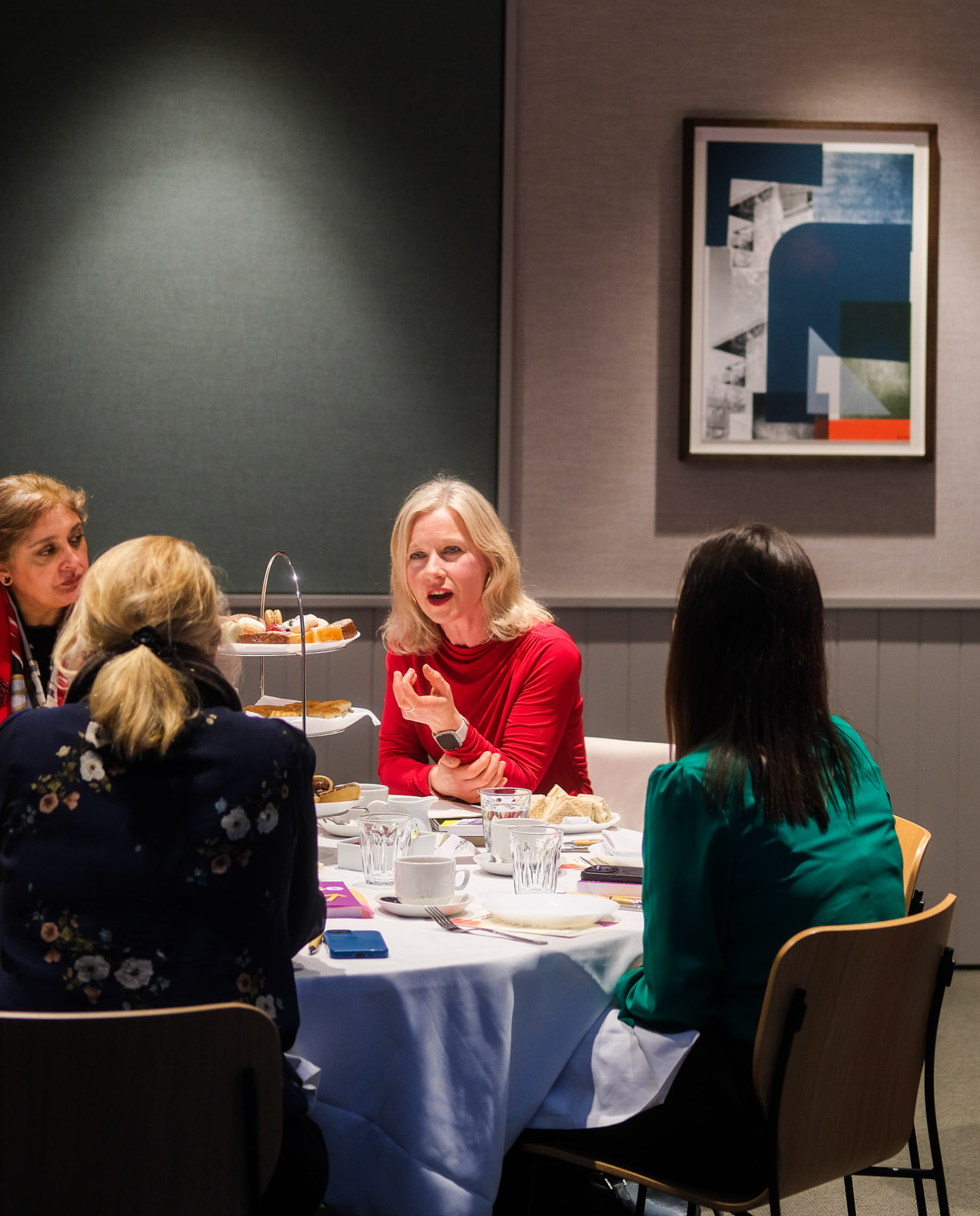 A speaker sharing her story at an EmpowerHER table